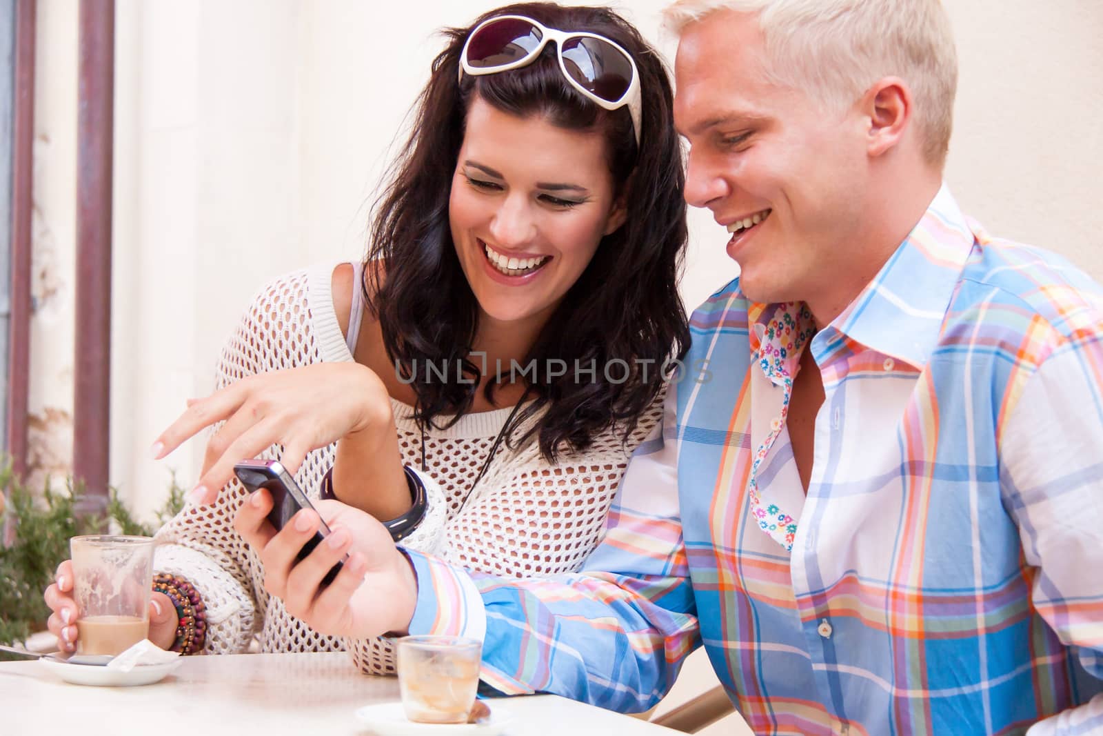 young smiling couple in cafe outdoor in summer by juniart