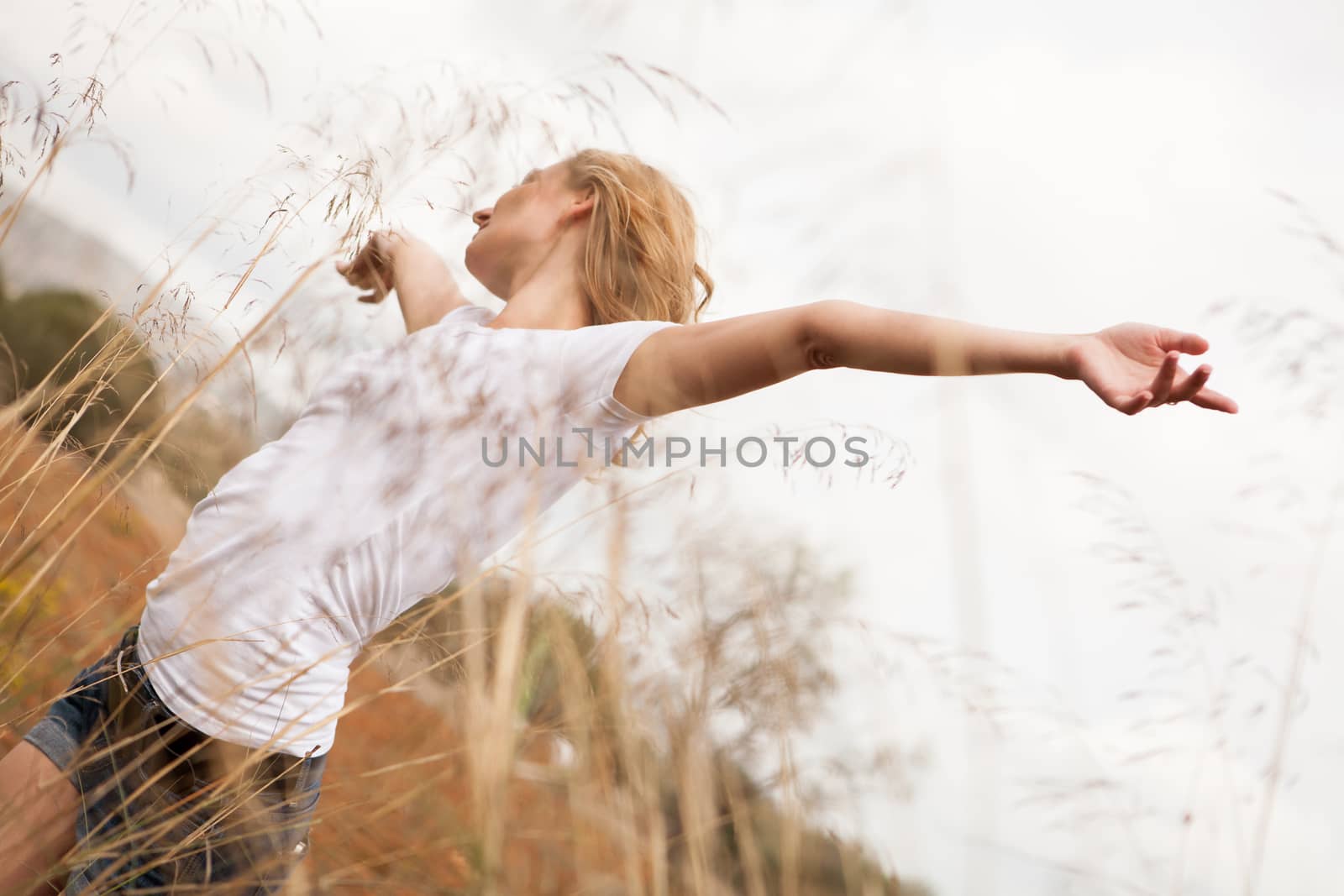 young happy attractive woman arms wide open nature outdoor breathing 