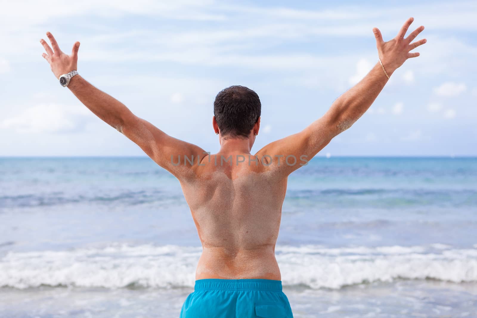 attractive young athletic man on the beach in summer outdoor vacation
