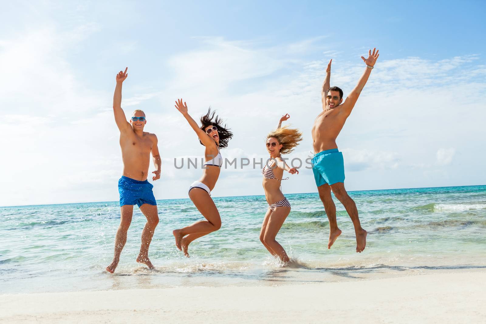 young happy friends havin fun on the beach summer holiday