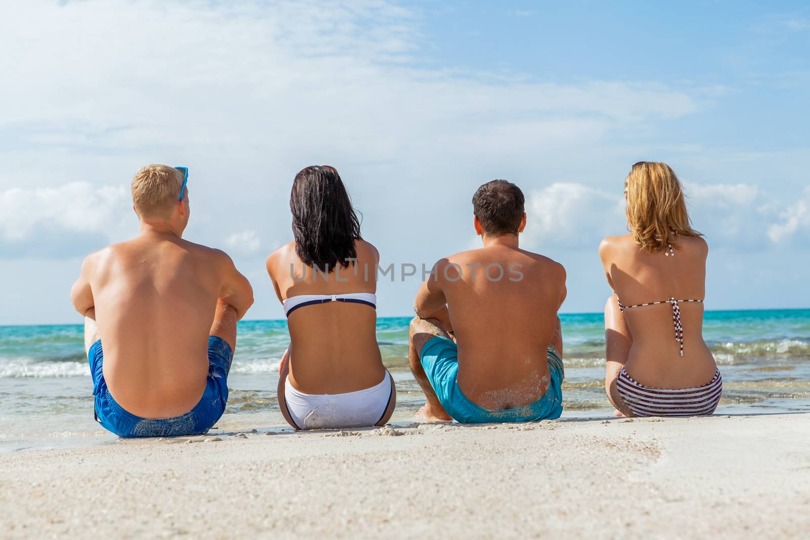 young happy friends havin fun on the beach summer holiday