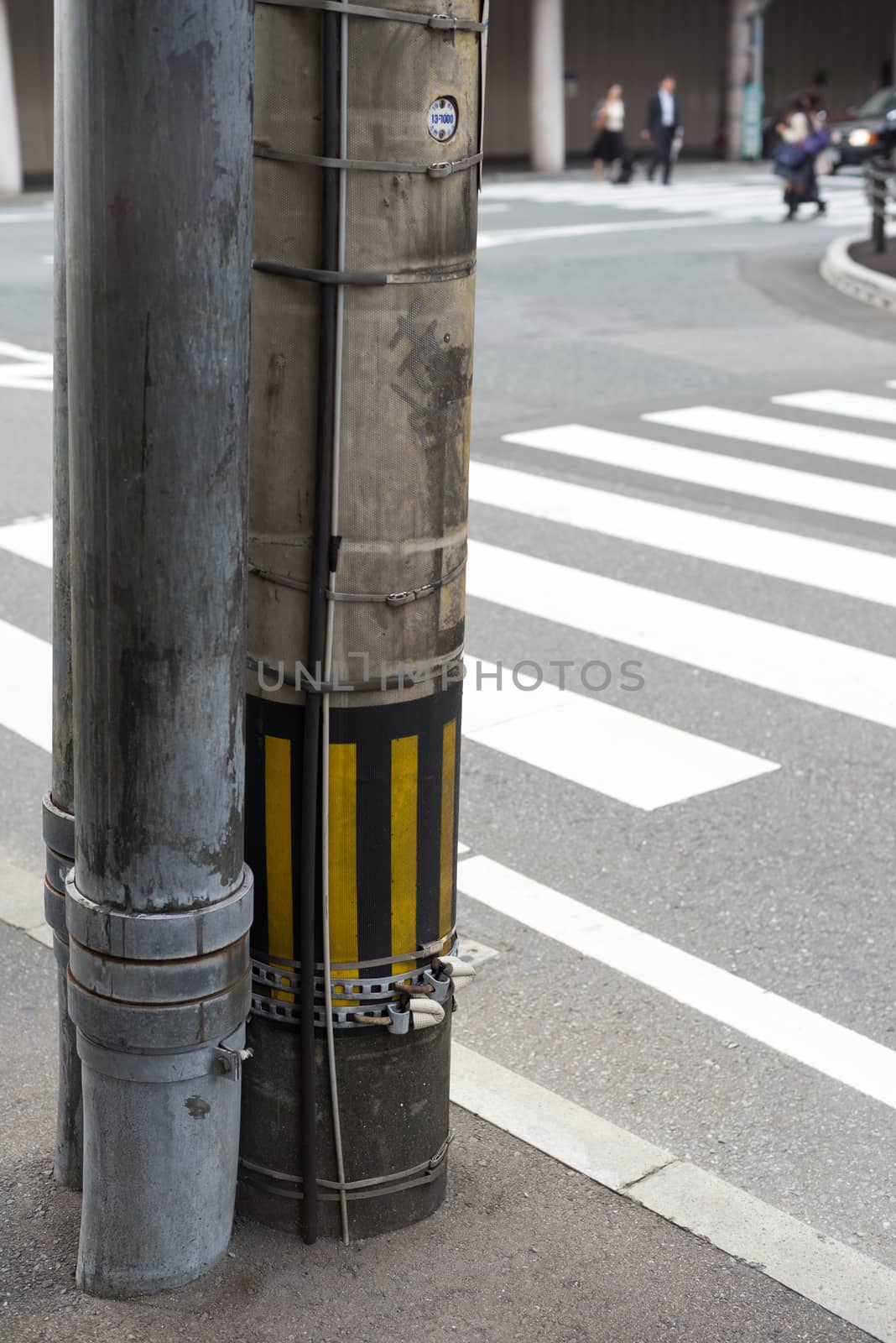 Electricity post in japan beside a crosswalk by iamway