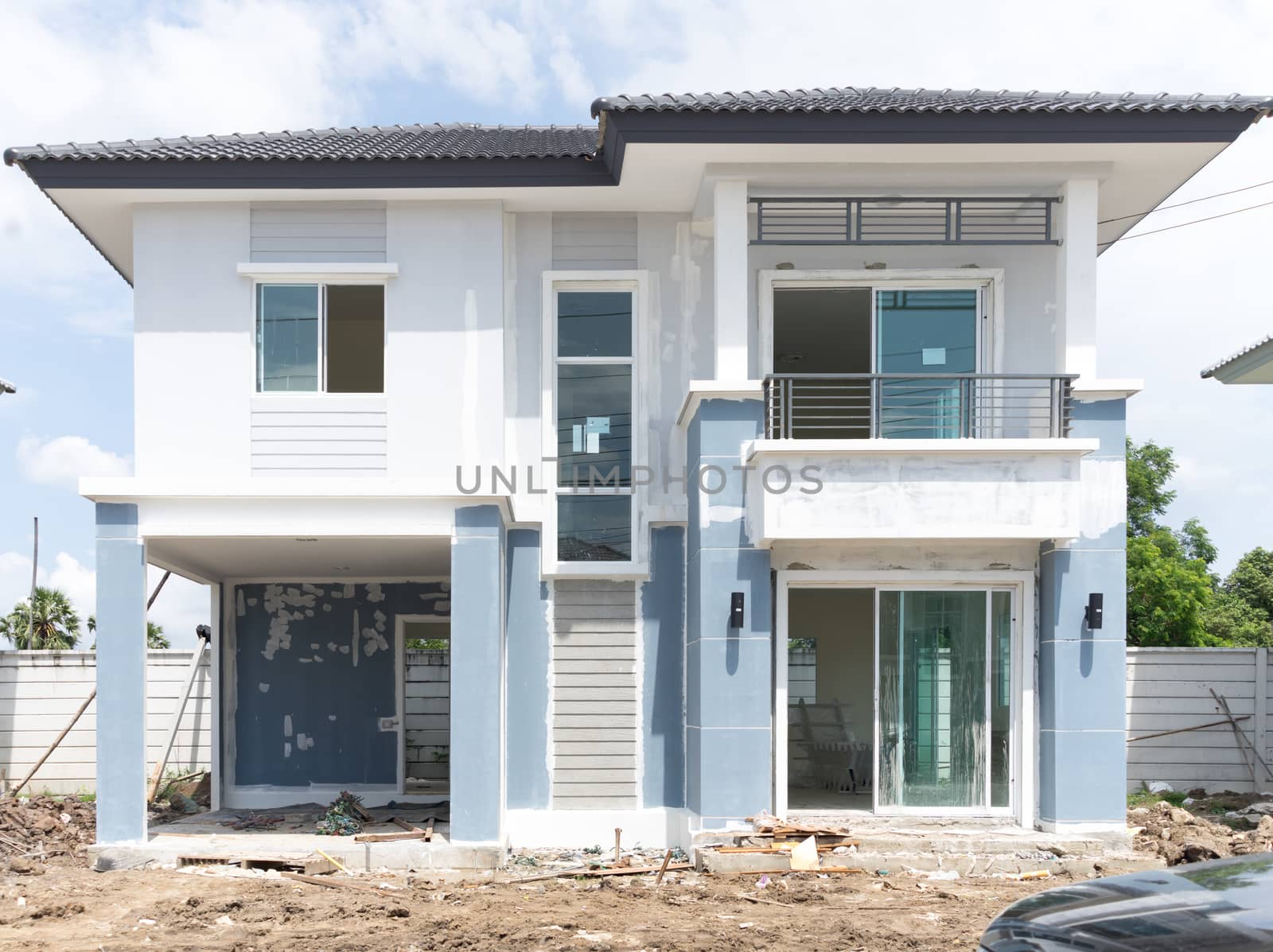 House under construction with many construction equipment were left in