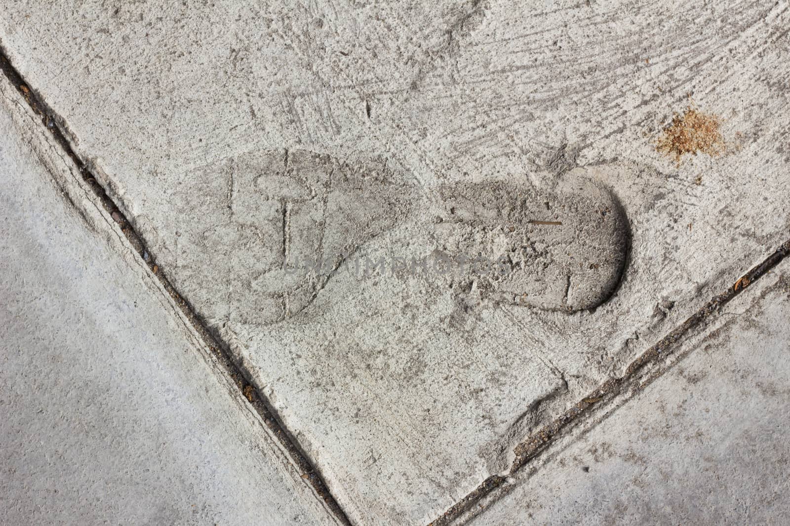 Man footprints on concrete track.