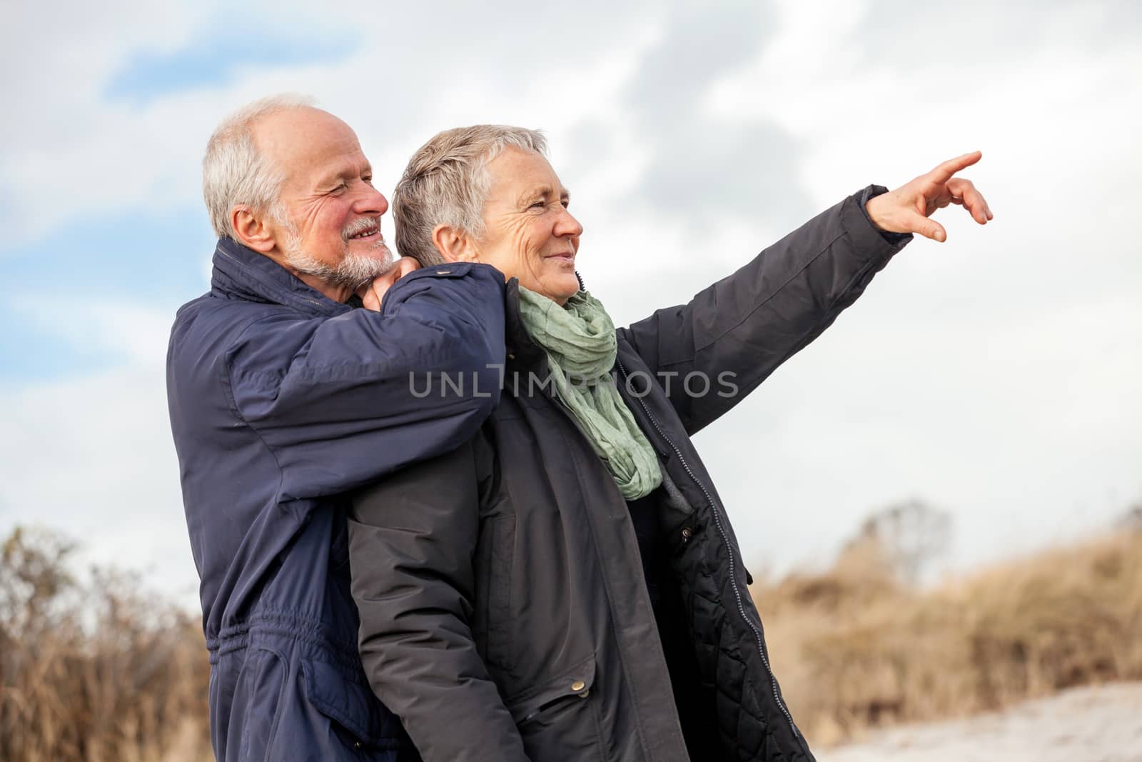 happy elderly senior couple walking on beach healthcare recreation