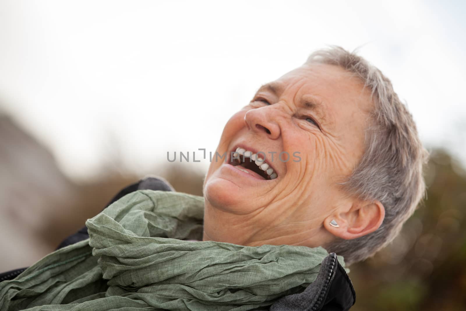 happy grey-haired elderly woman senior outdoor portrait smiling