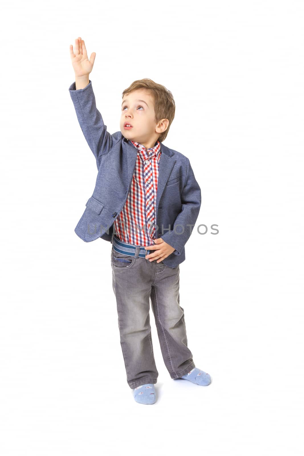 little boy with jacket and shirt with his hand lifted up on white background