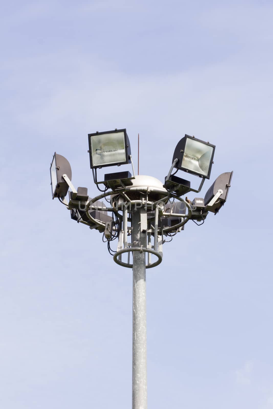 Stadium football game light pole in daytime.