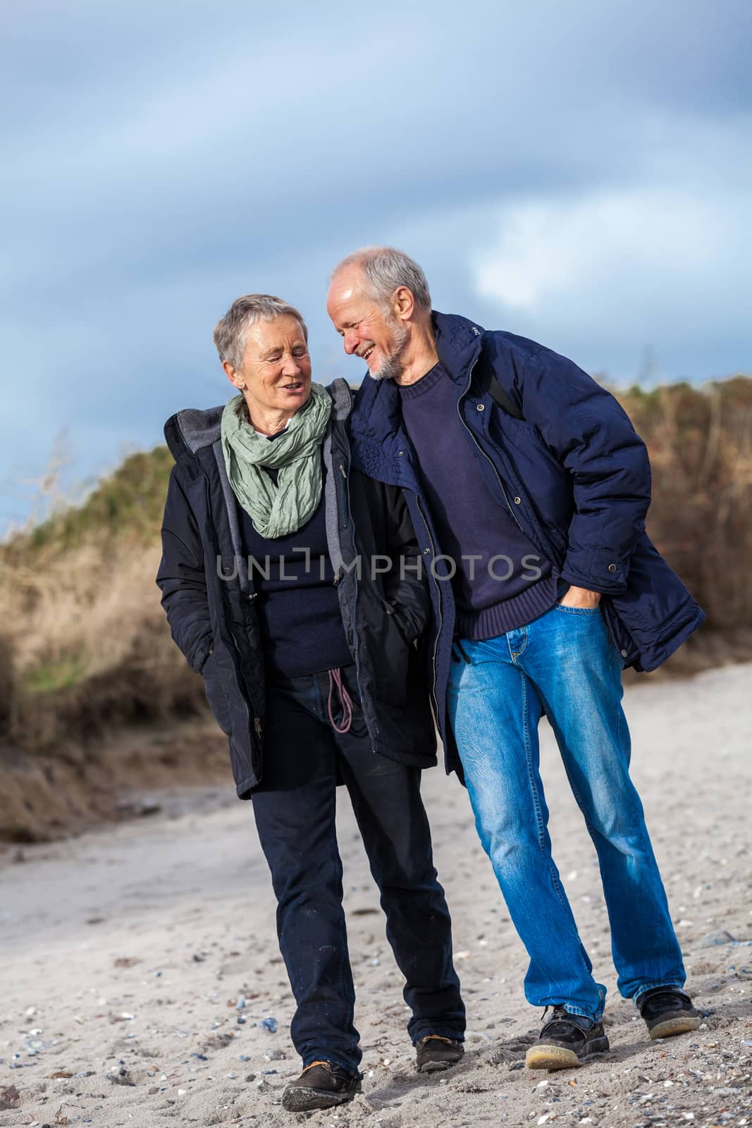 happy elderly senior couple walking on beach by juniart