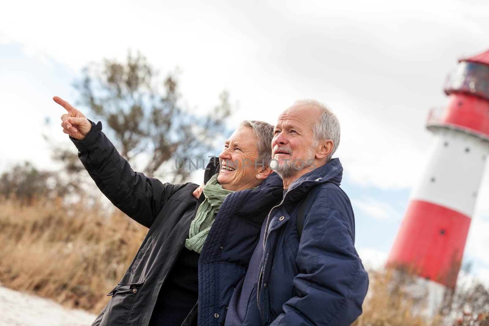 happy mature couple relaxing baltic sea dunes in autumn