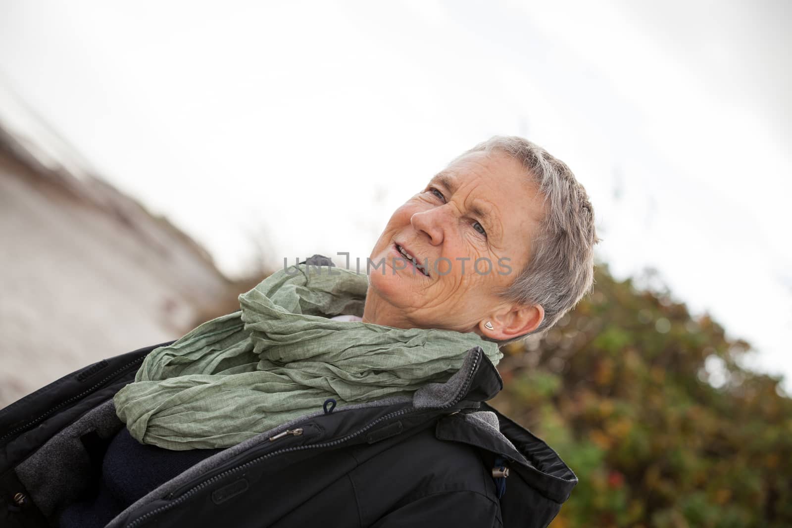 happy grey-haired elderly woman senior outdoor portrait smiling