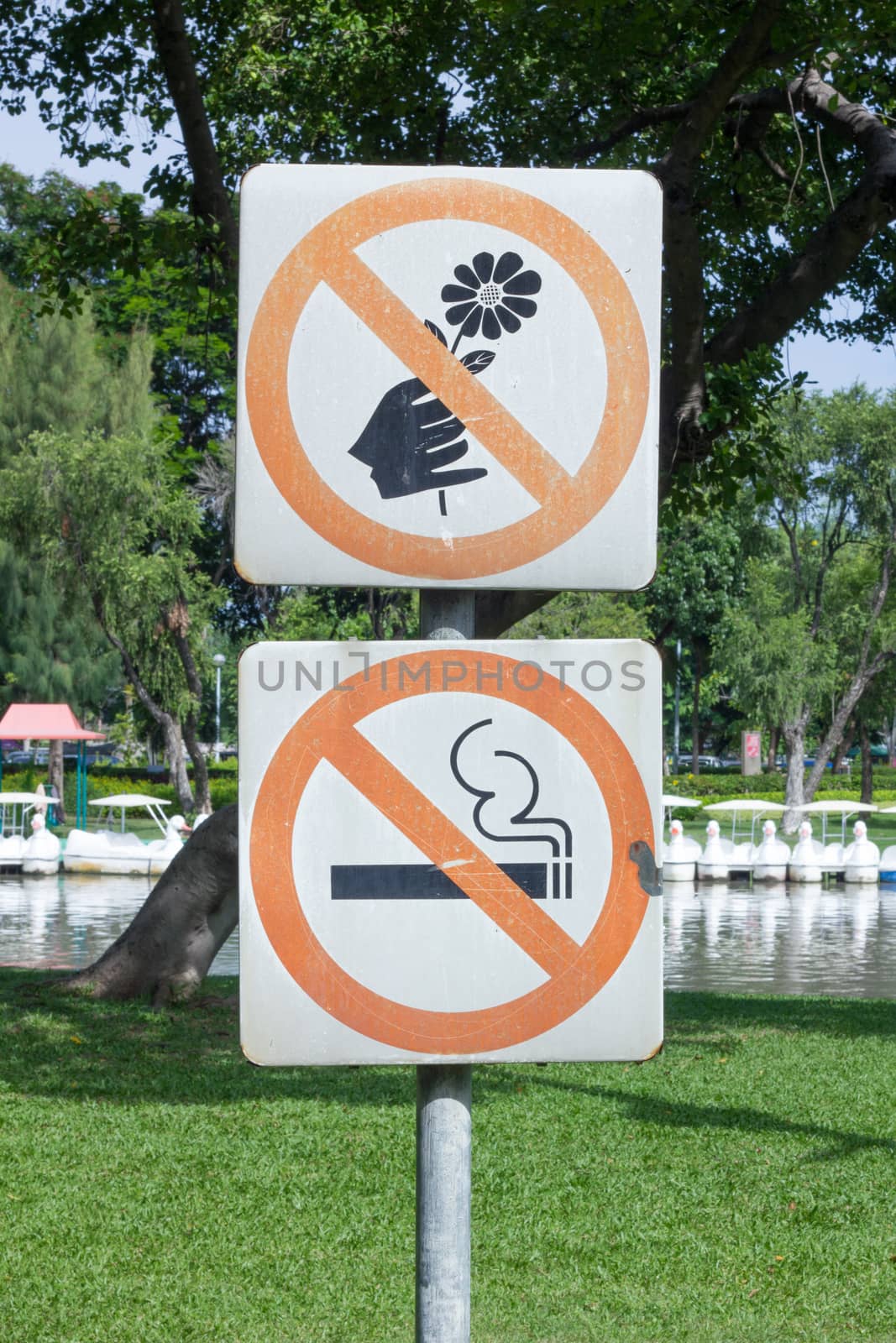 no smoking and do not pick flower, metal sign in the park