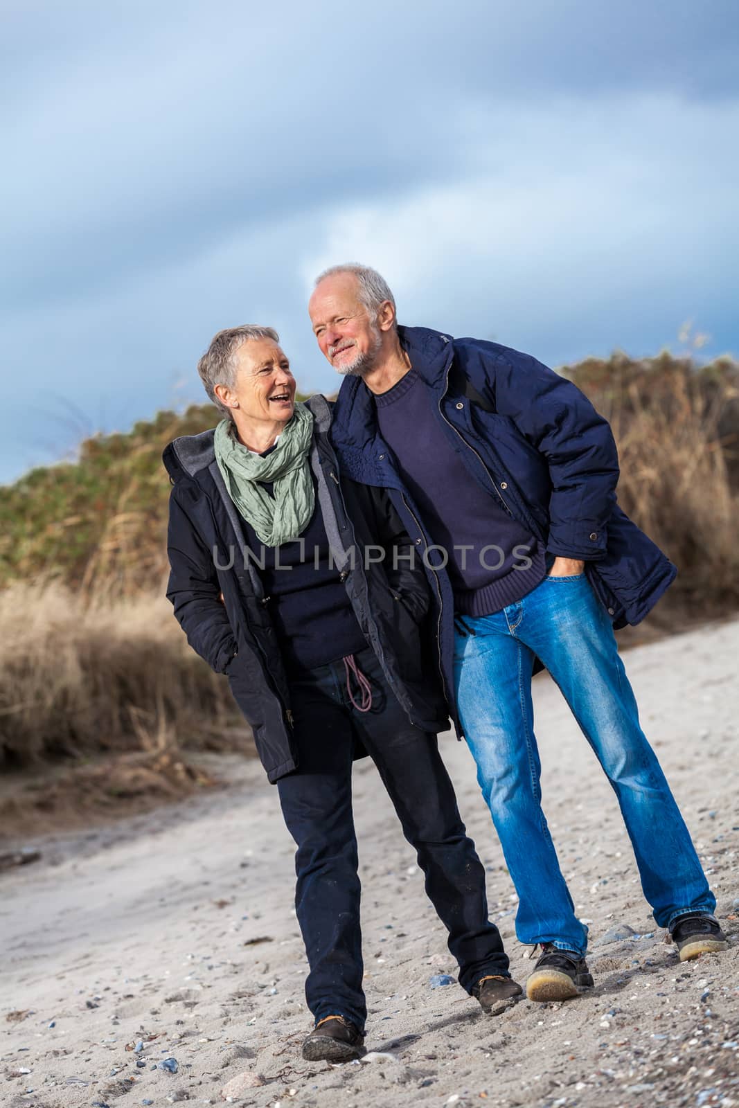 happy elderly senior couple walking on beach by juniart