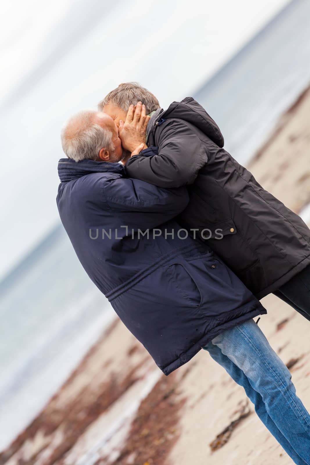 happy elderly senior couple walking on beach by juniart