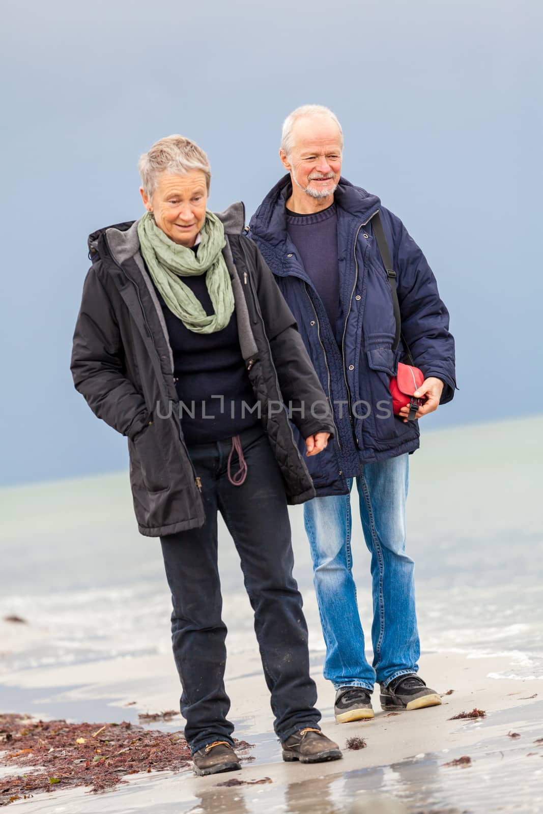 happy elderly senior couple walking on beach healthcare recreation