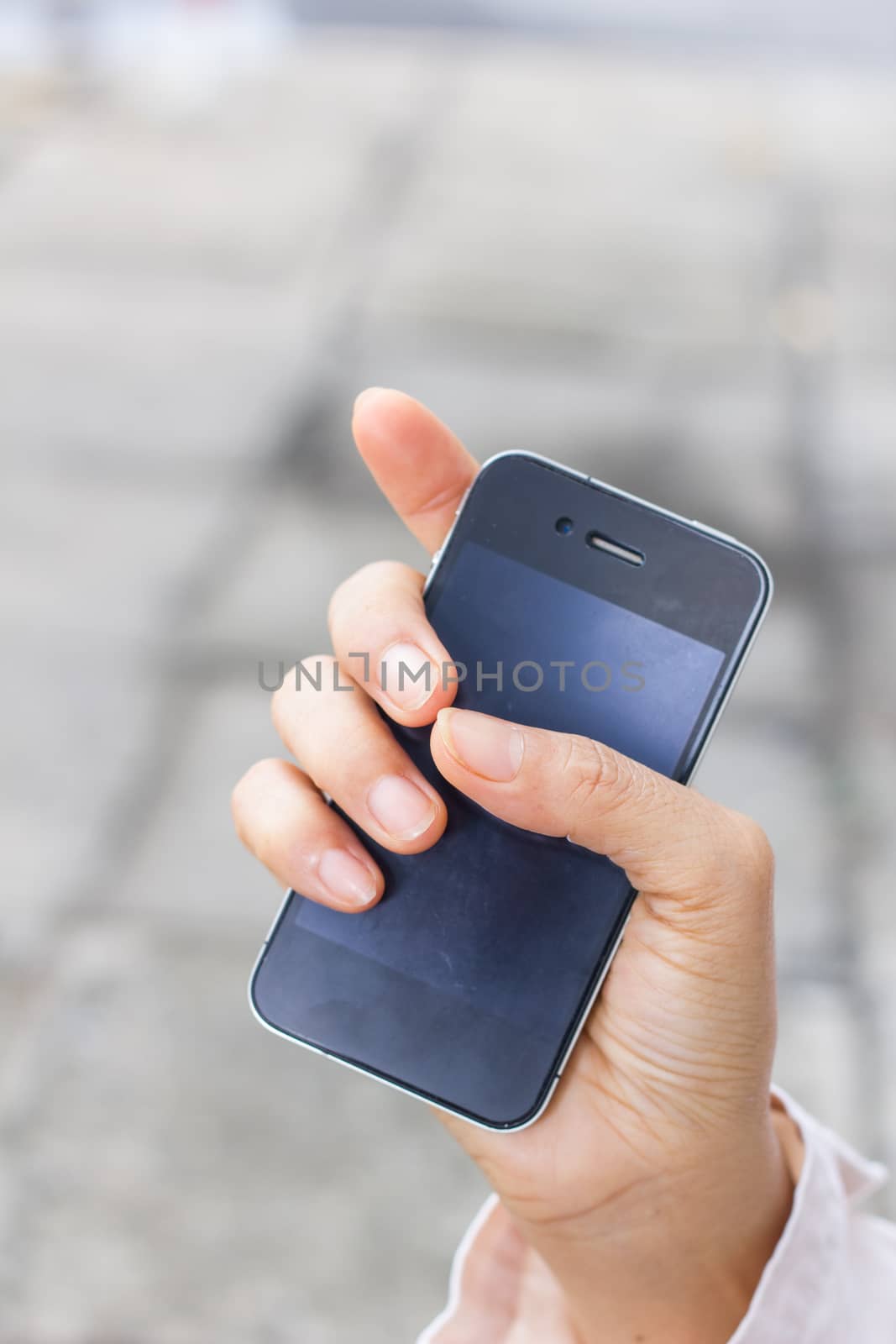 Mobile phone in woman hand by a3701027