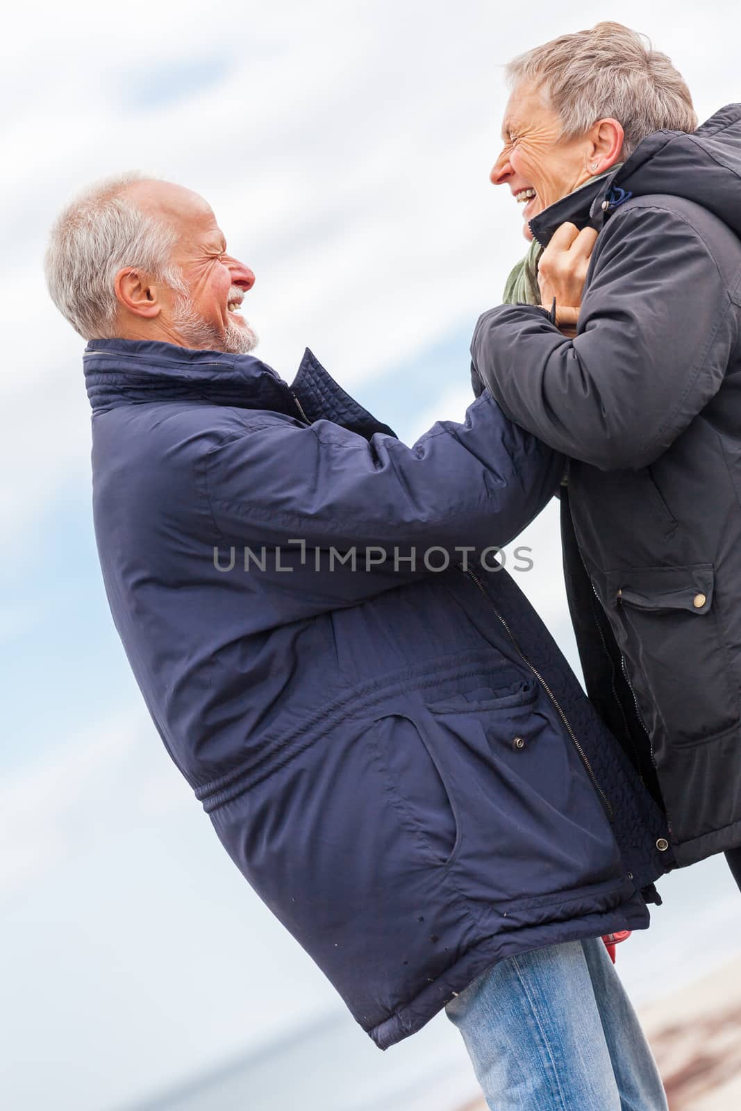 happy elderly senior couple walking on beach healthcare recreation