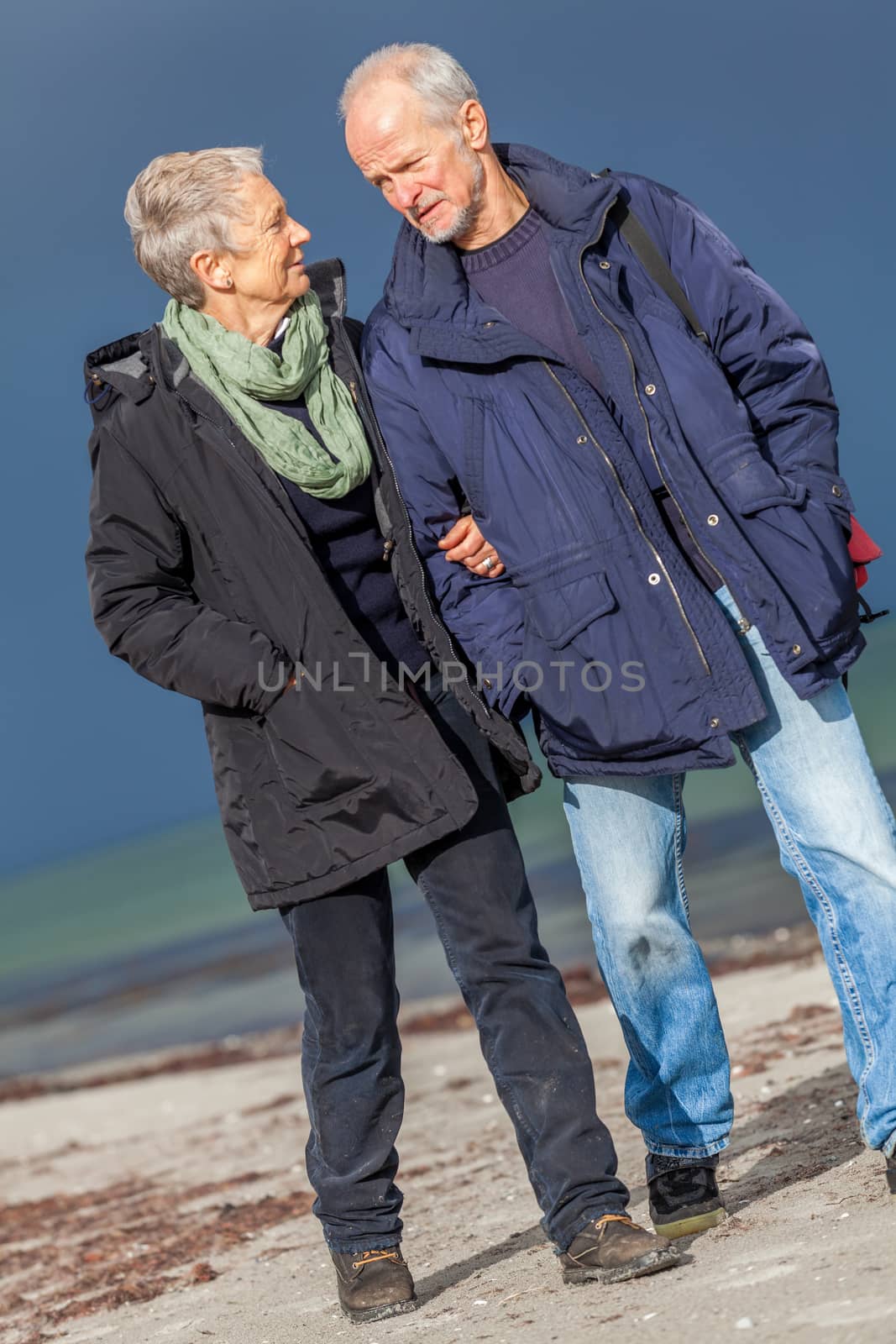 happy elderly senior couple walking on beach by juniart