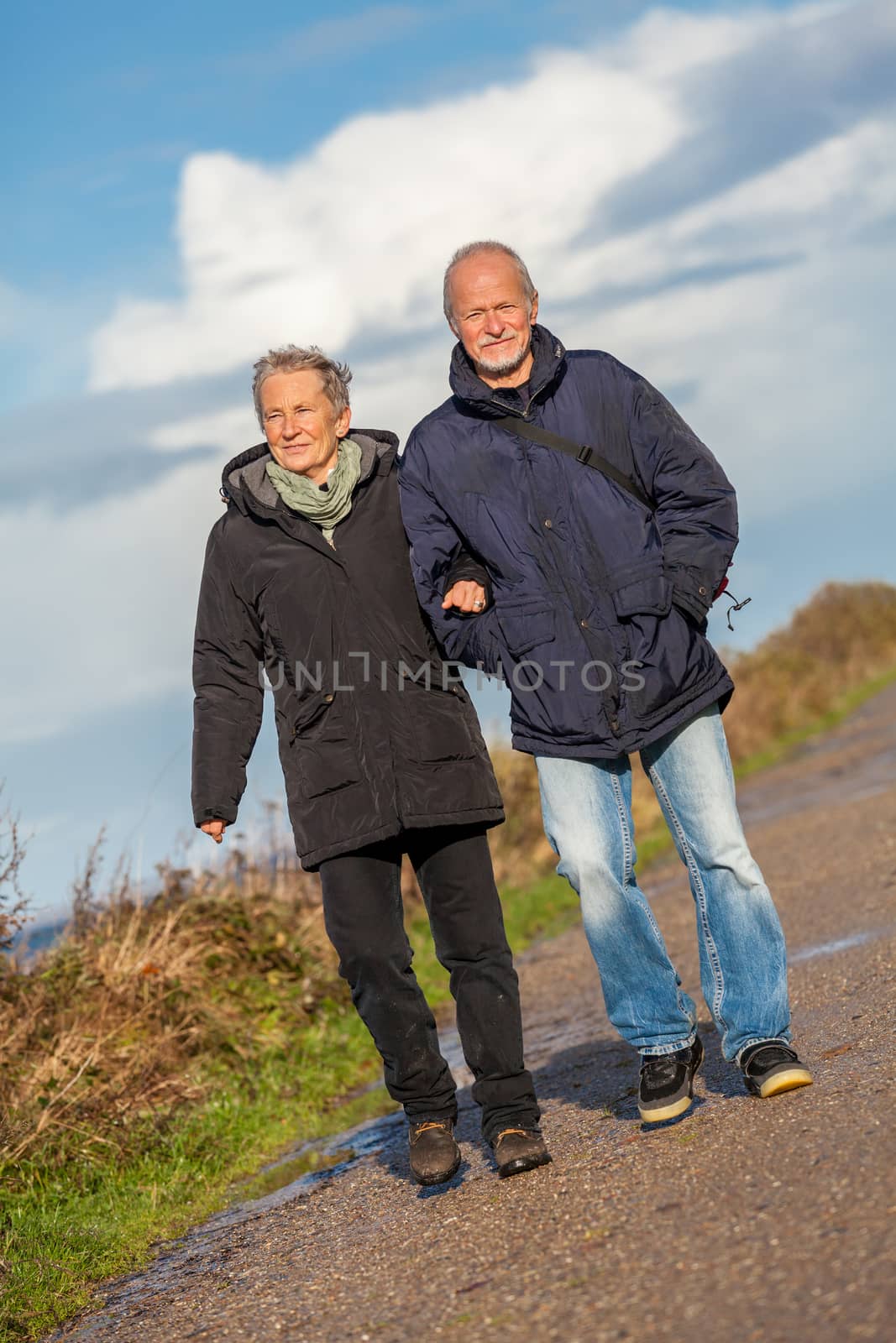 happy mature couple relaxing baltic sea dunes  by juniart