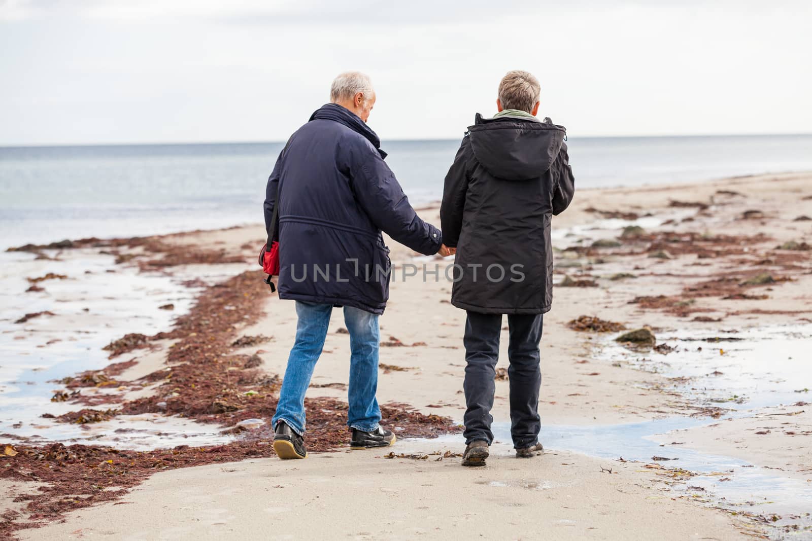 happy elderly senior couple walking on beach healthcare recreation