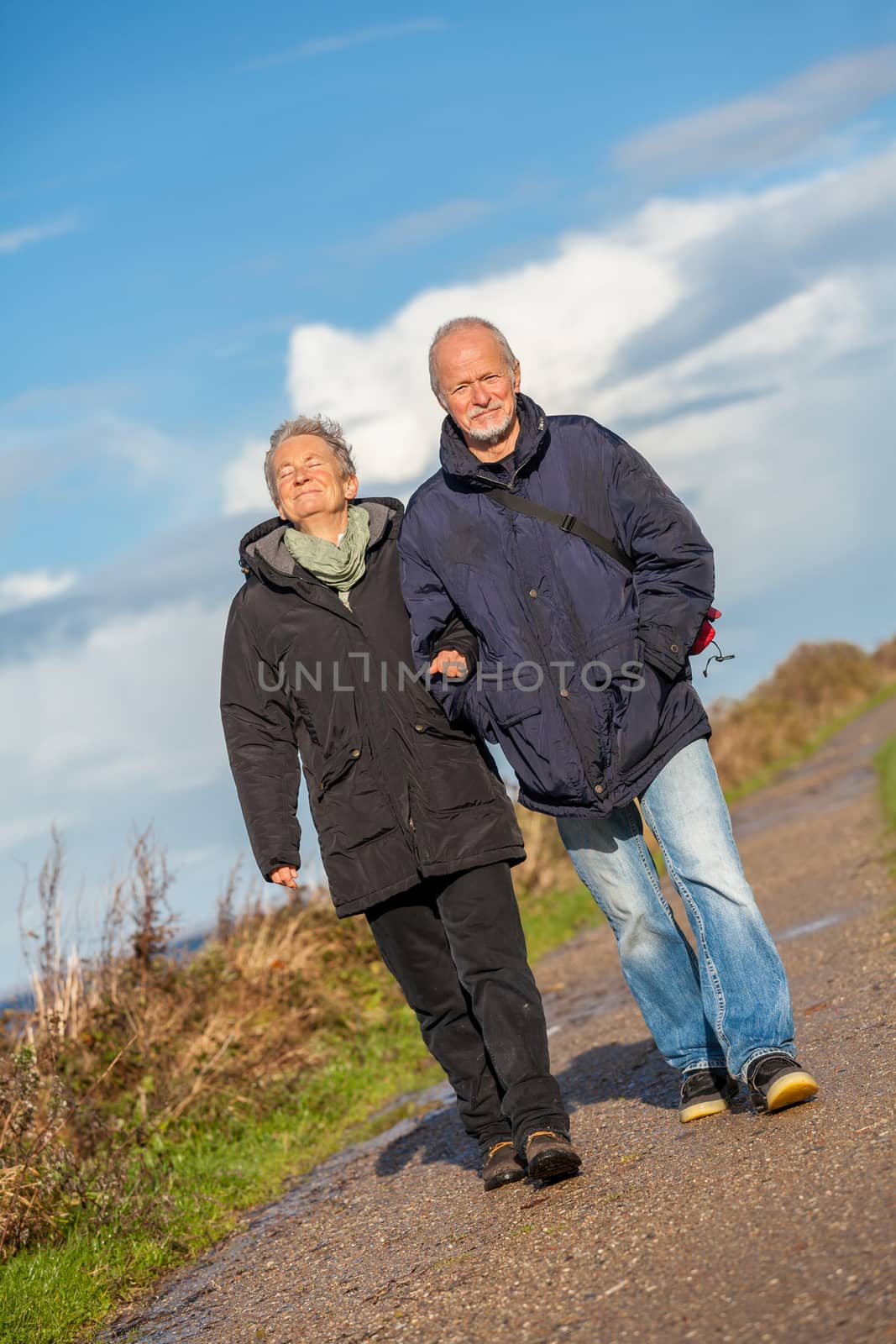 happy mature couple relaxing baltic sea dunes  by juniart