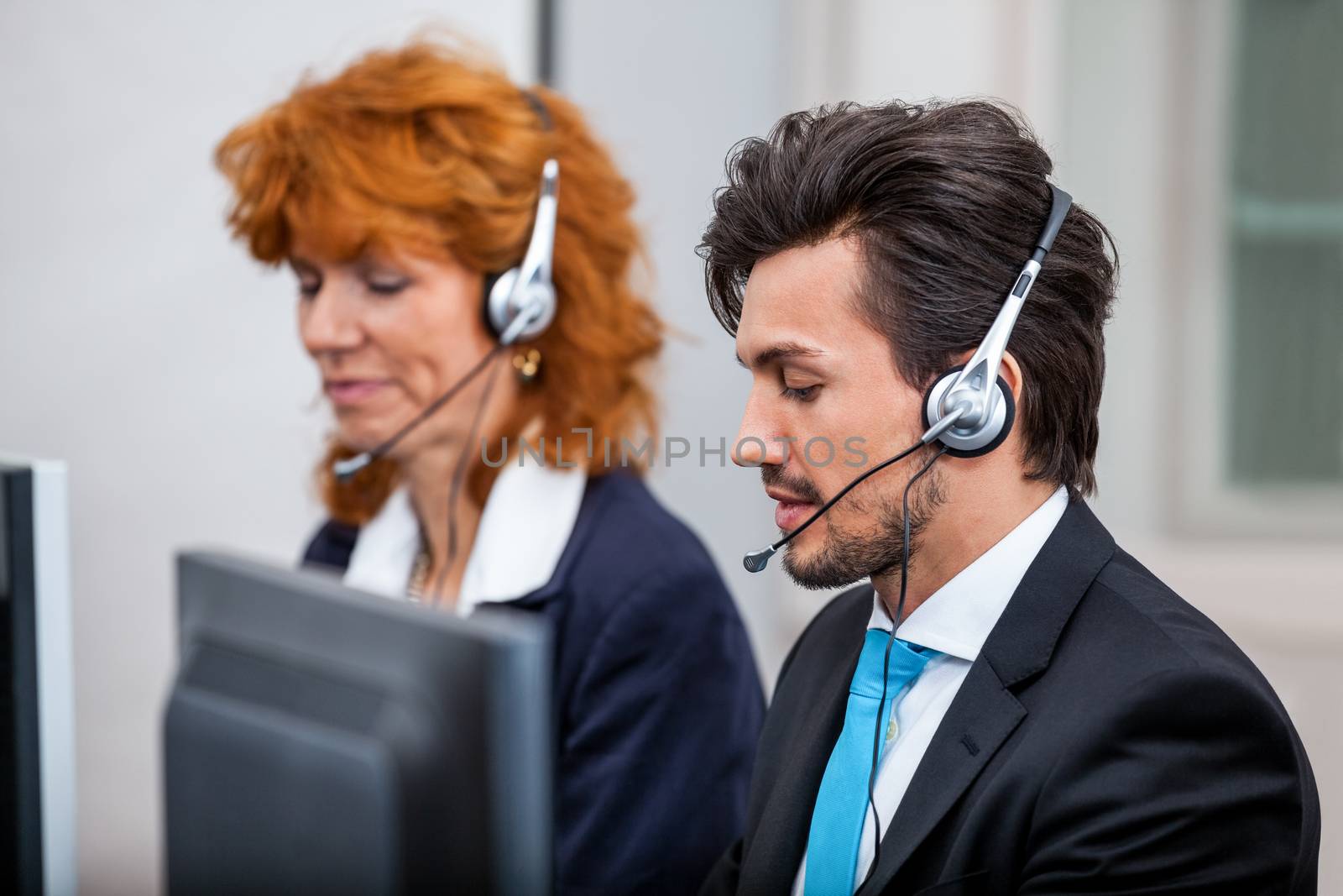 friendly callcenter agent operator with headset telephone  by juniart