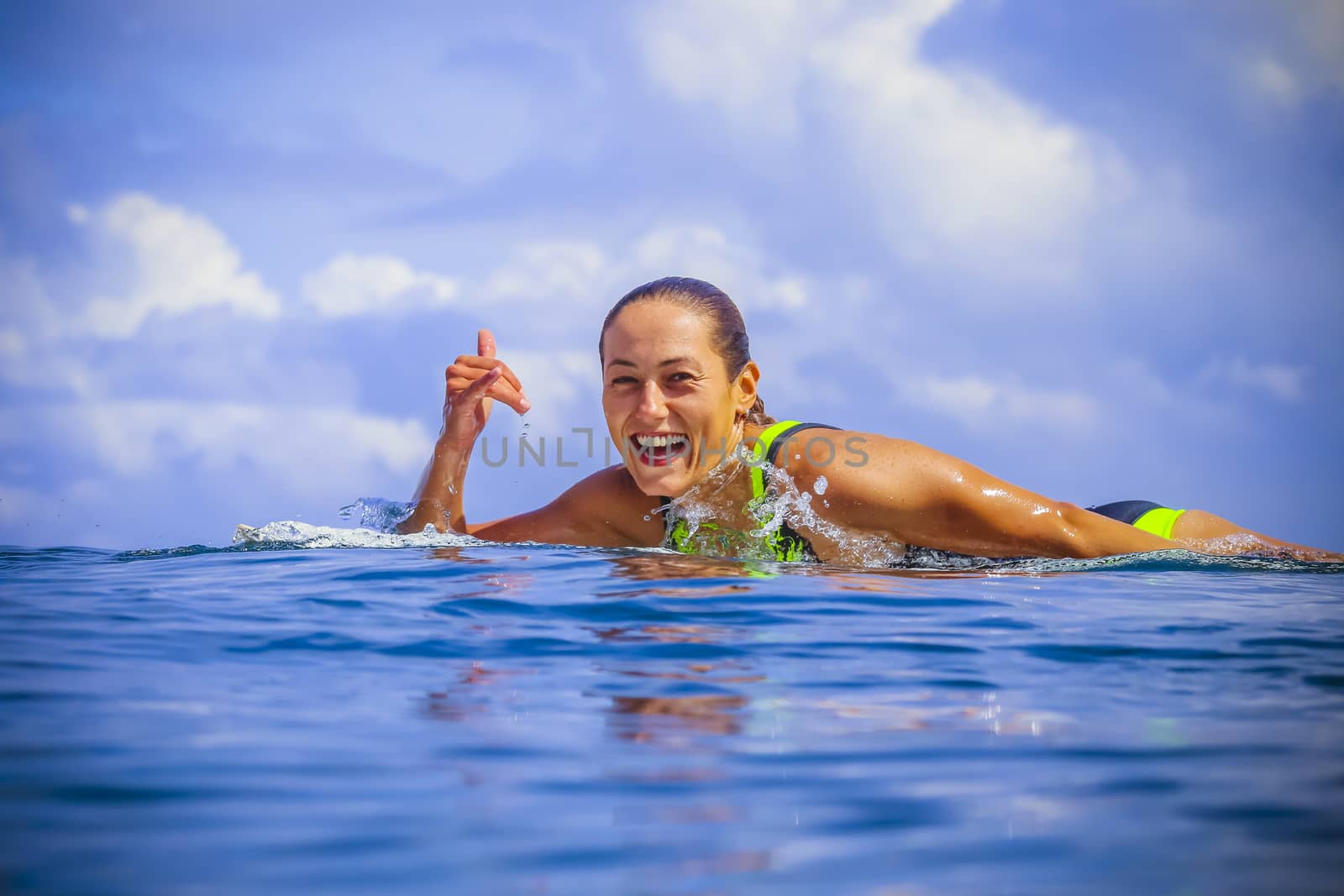 Surfer girl on Amazing Blue Wave, Bali island.