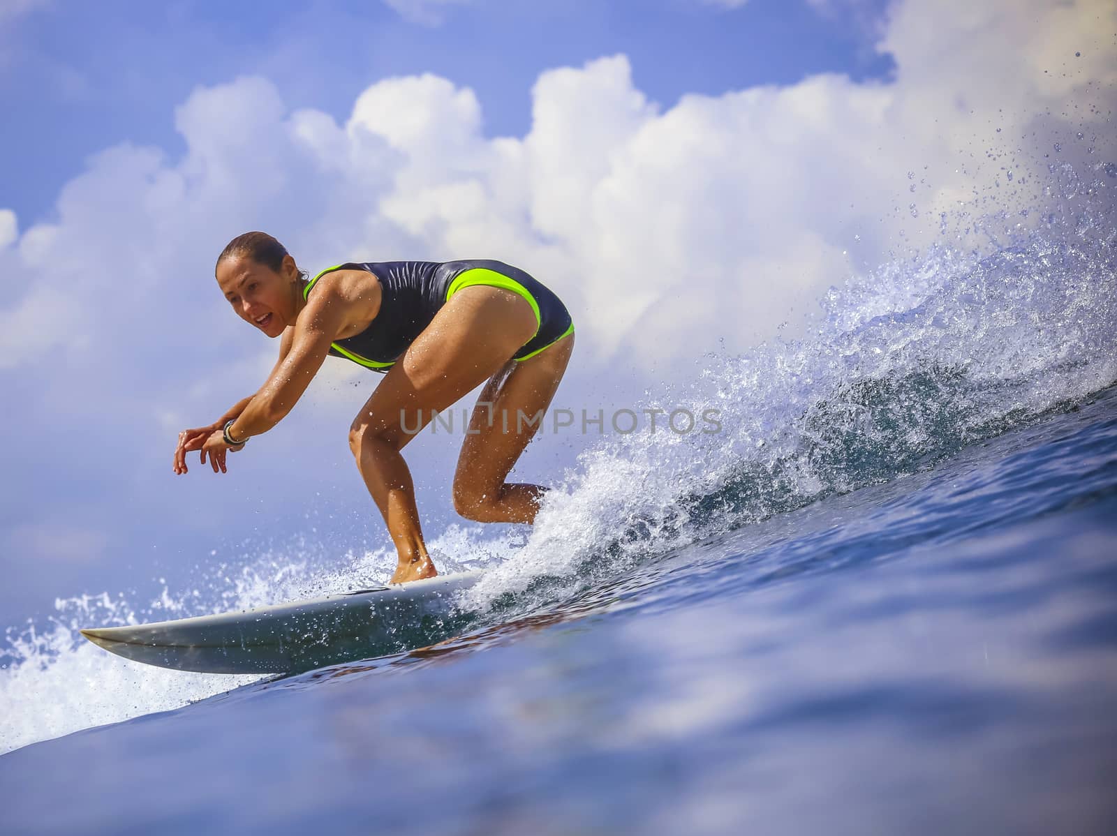 Surfer girl on Amazing Blue Wave, Bali island.