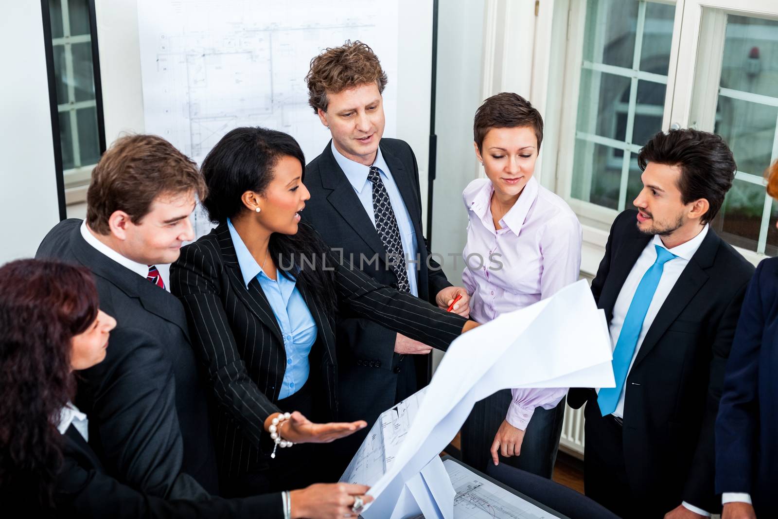 business people discussing architecture plan sketch  by juniart