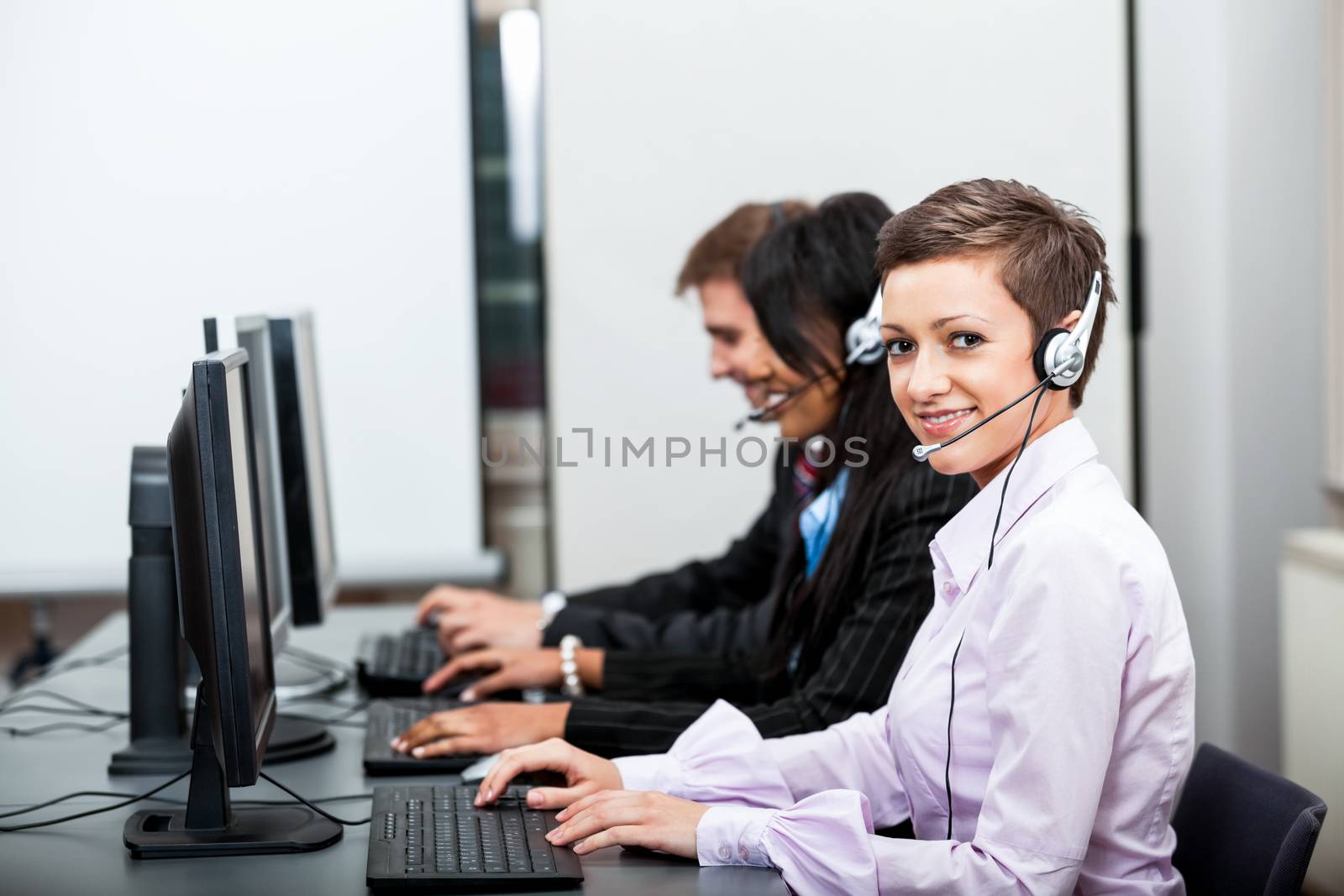 smiling callcenter agent with headset support by juniart