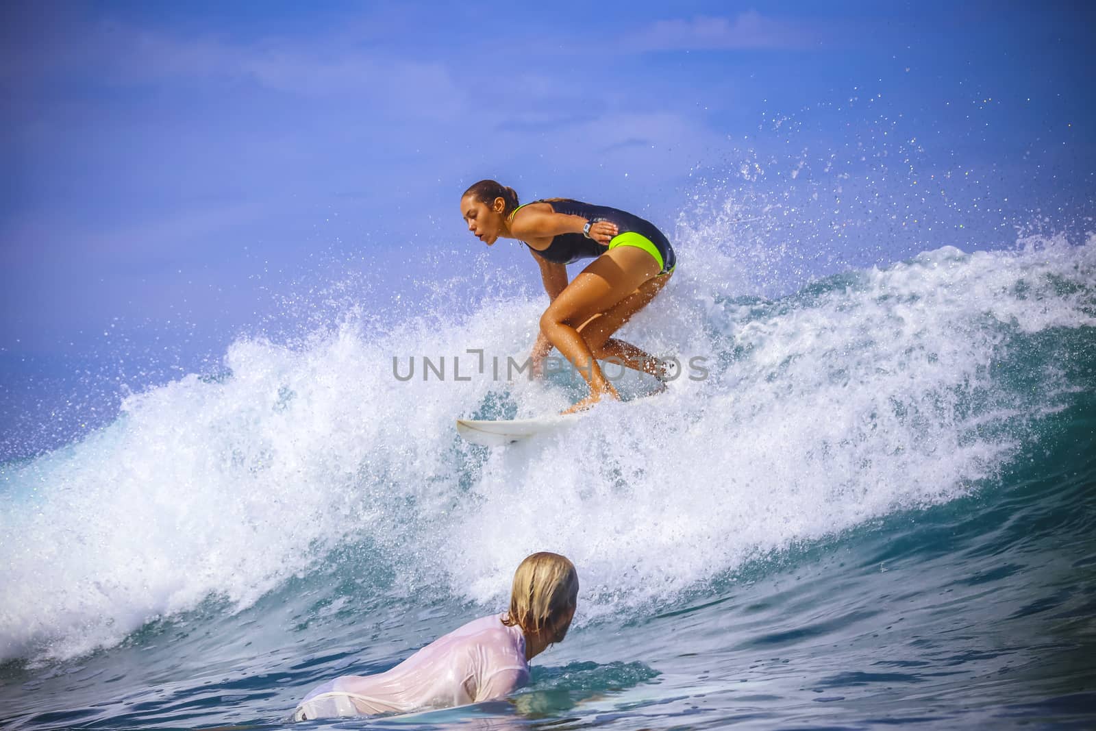 Surfer girl on Amazing Blue Wave, Bali island.