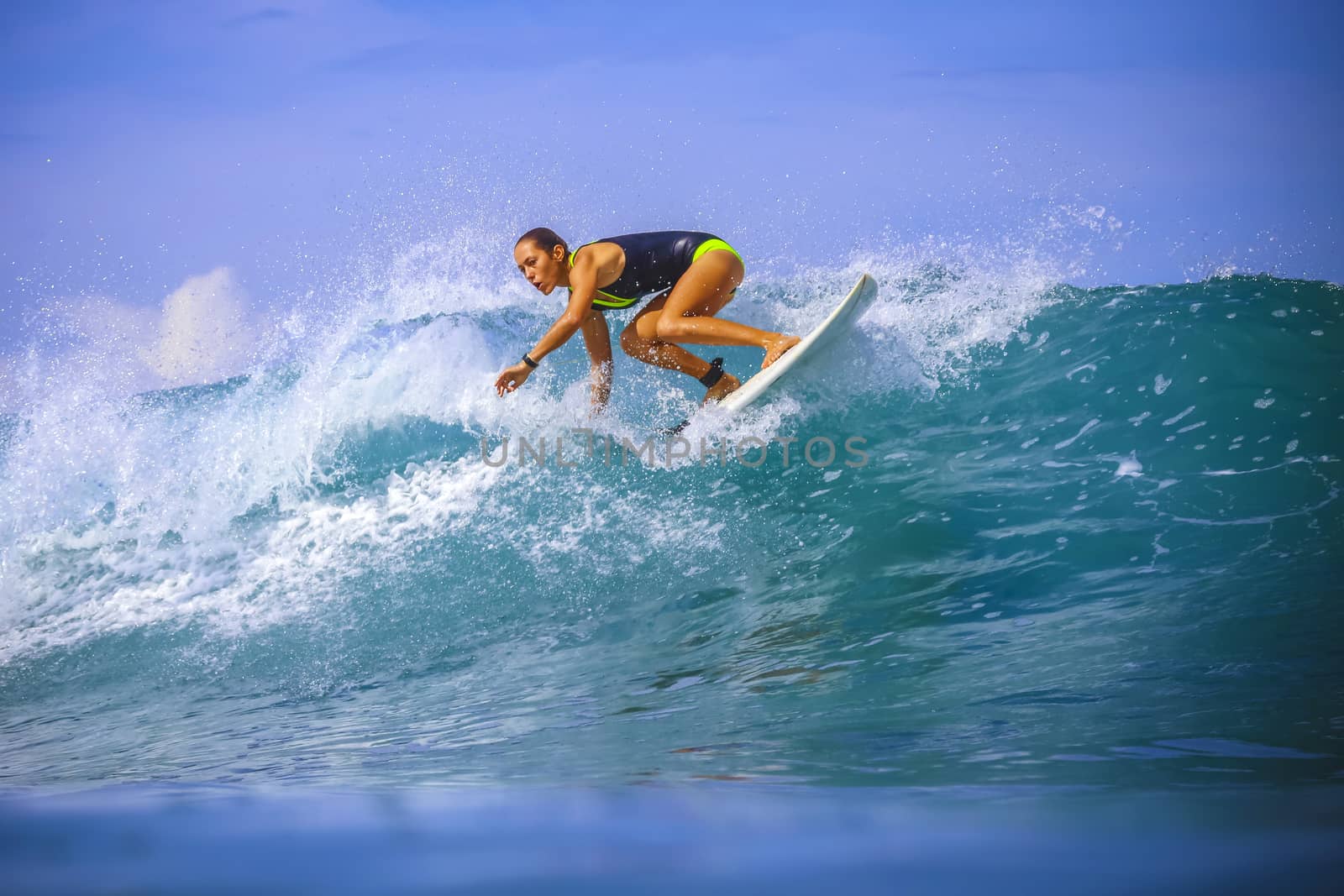 Surfer girl on Amazing Blue Wave, Bali island.