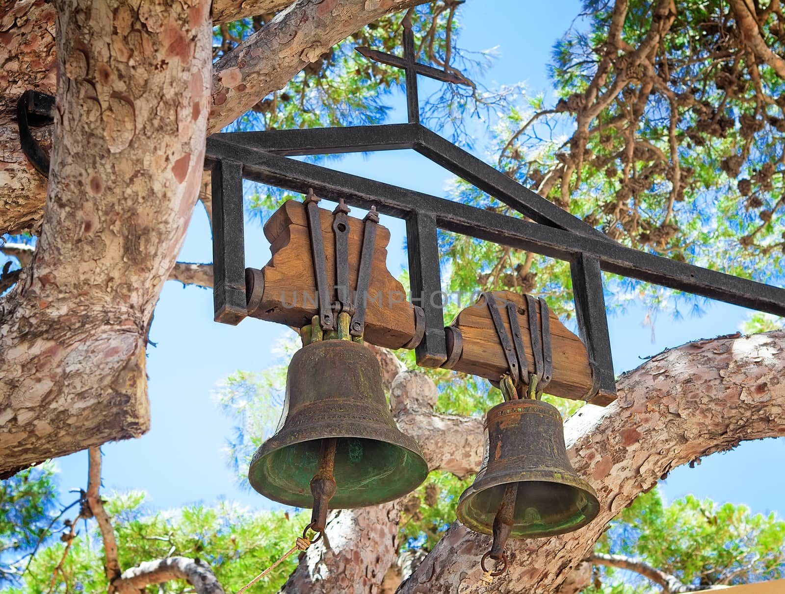 Two ancient bells in the Orthodox monastery of Preveli, Crete, Greece. Located on the branches of the old tree.