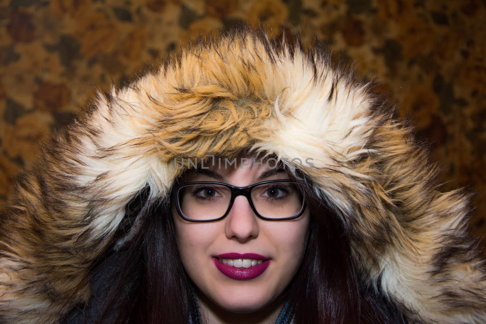 Young caucasian girl wearing a hood, getting ready to go out in cold!