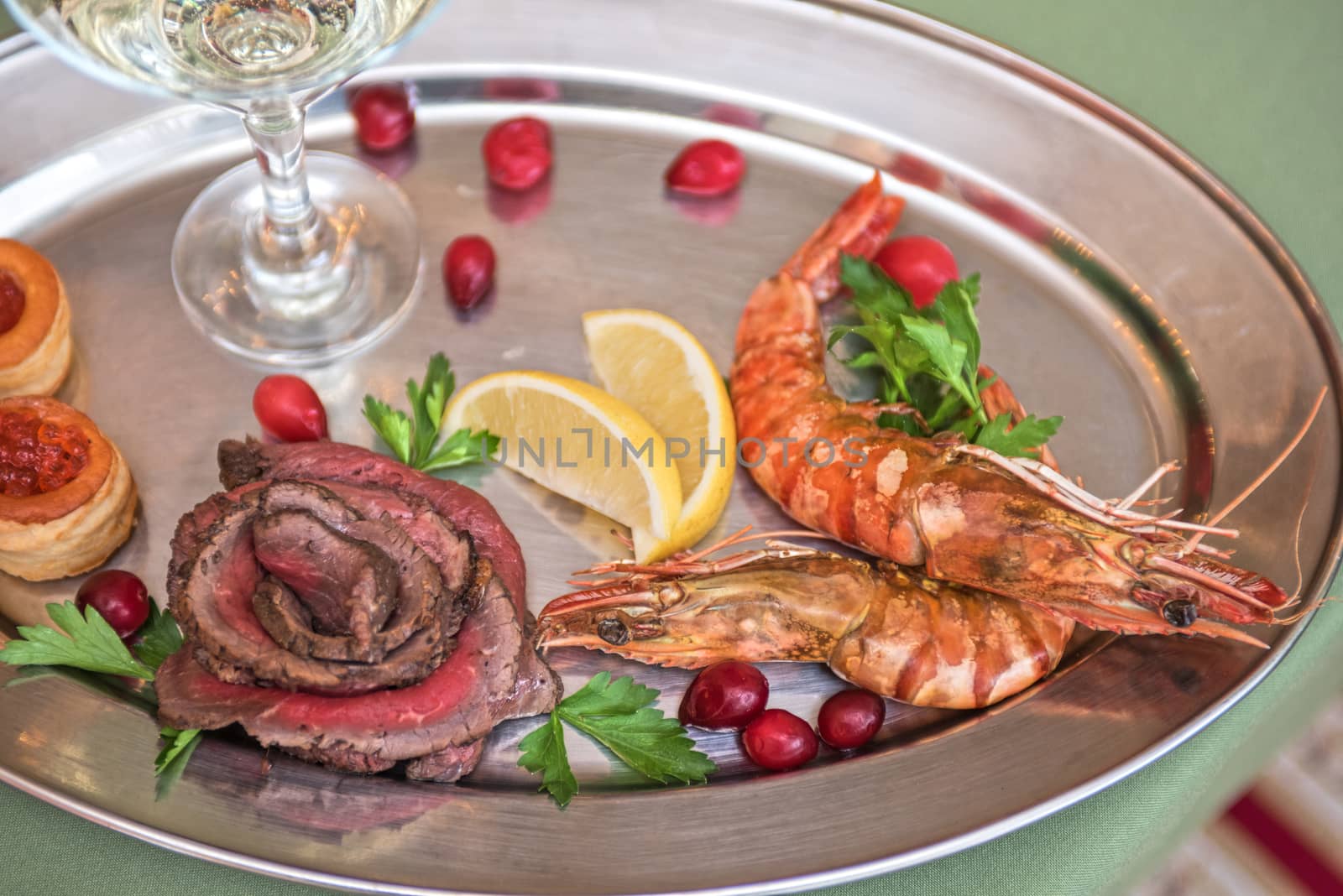 Grilled shrimps and beef meat on a plate