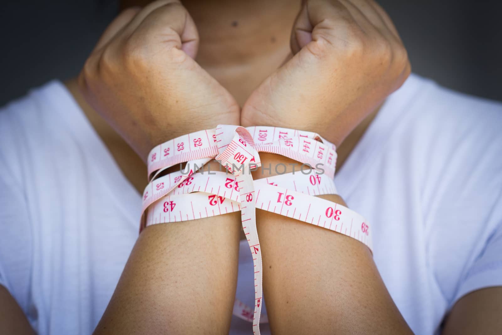 woman's hands gets tied up with tapeline, with vignette