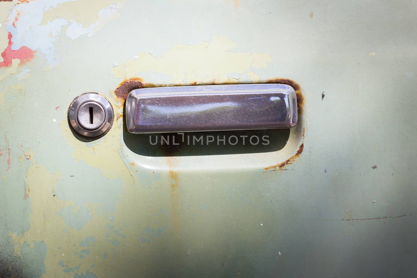 old rusty car door with keyhold.