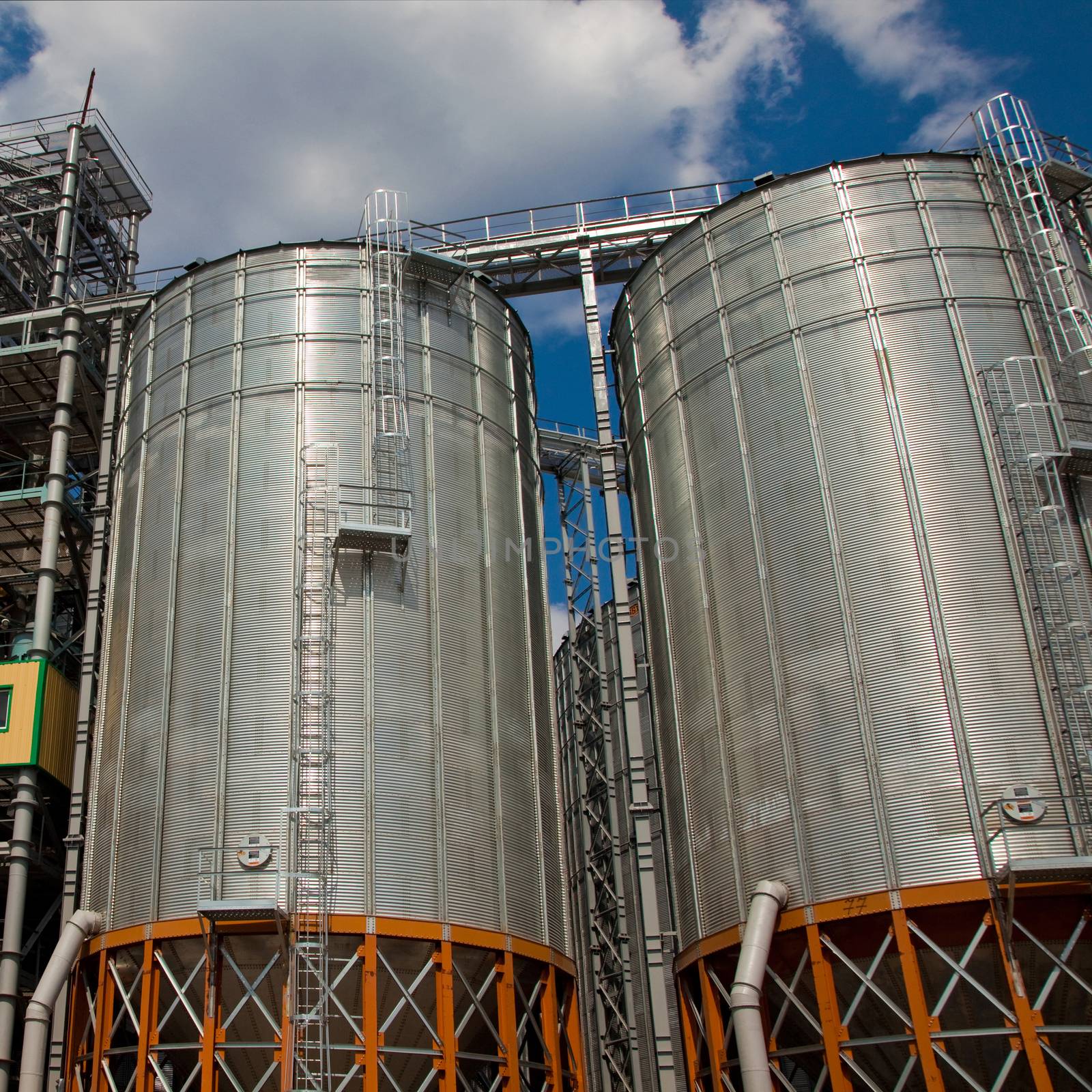 Towers of grain drying enterprise. metal grain facility with silos