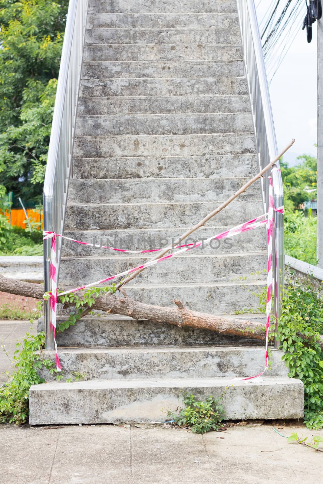 abandoned Flyover stairs with log and plastic lines.