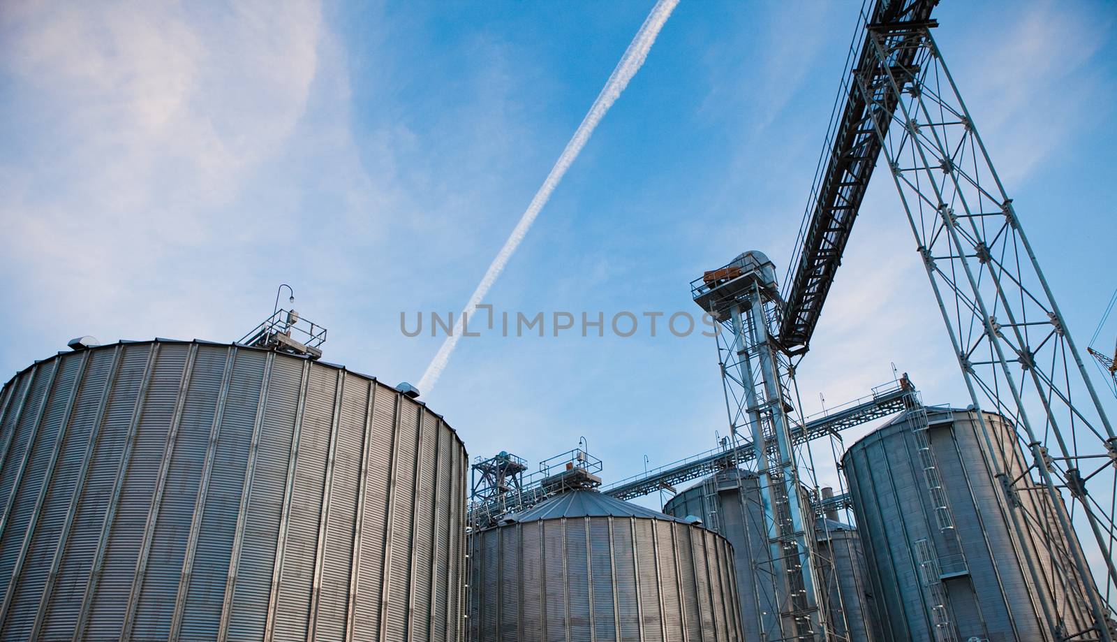 Towers of grain drying enterprise at sunny day by sarymsakov