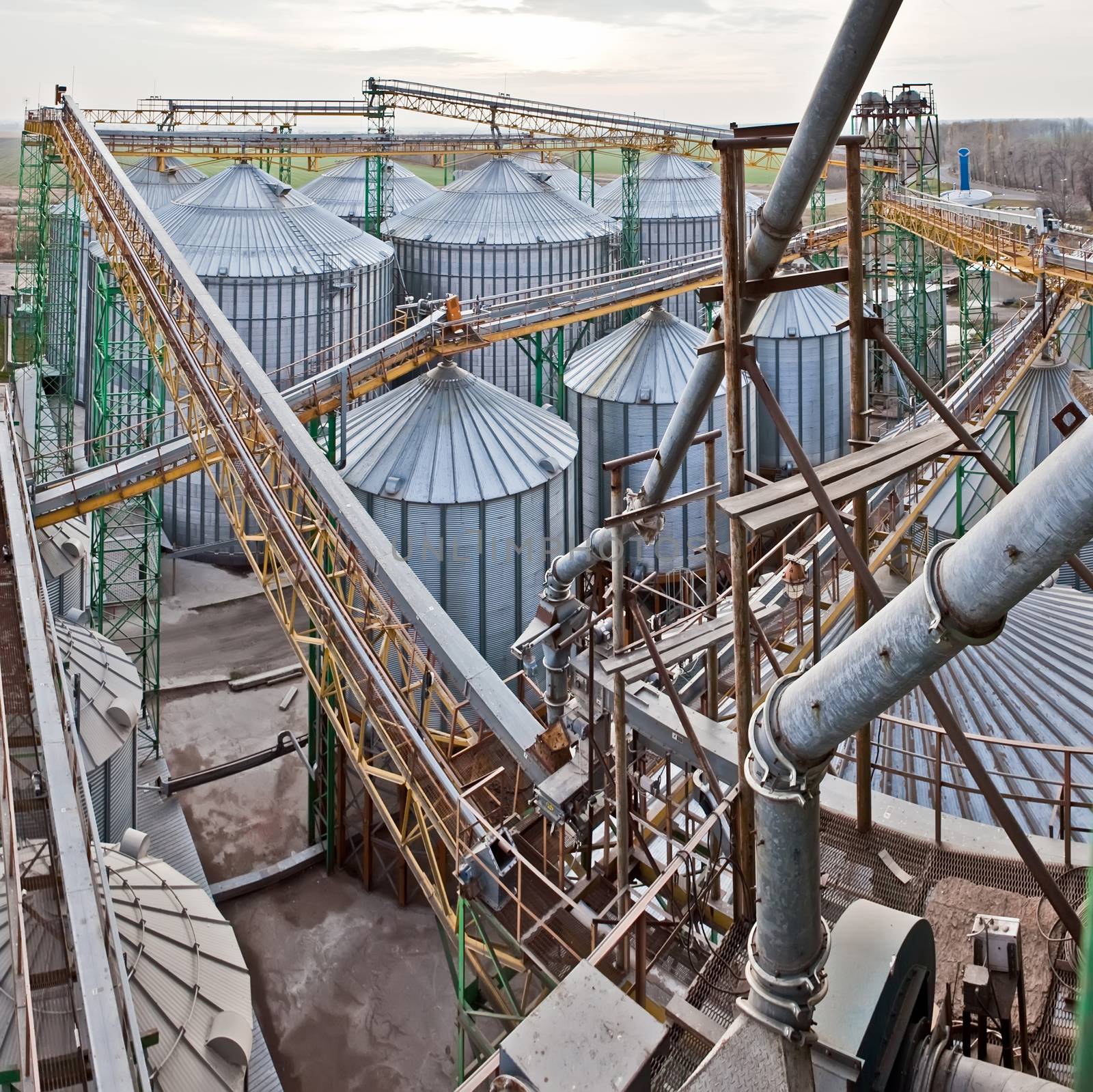 Towers of grain drying enterprise at sunny day by sarymsakov