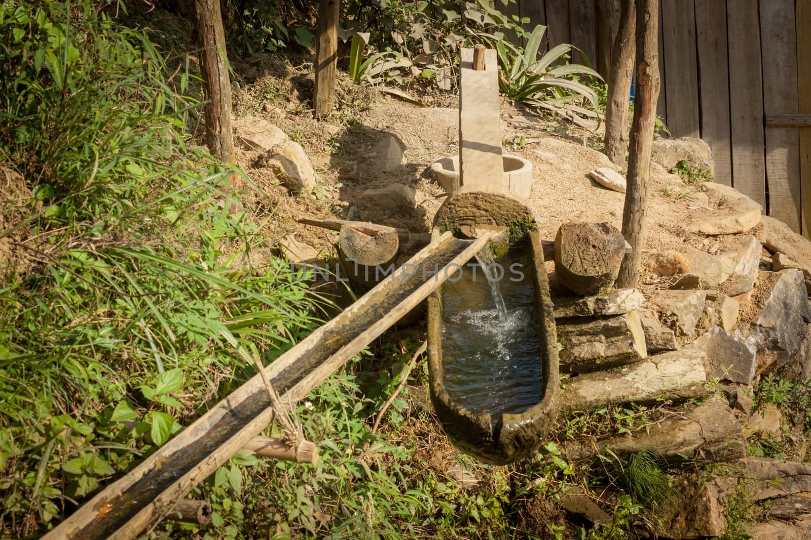 Large mallet and mortar for pounding paddy to separate the grains from the chaff, action for water power in Sapa, Vietnam. 