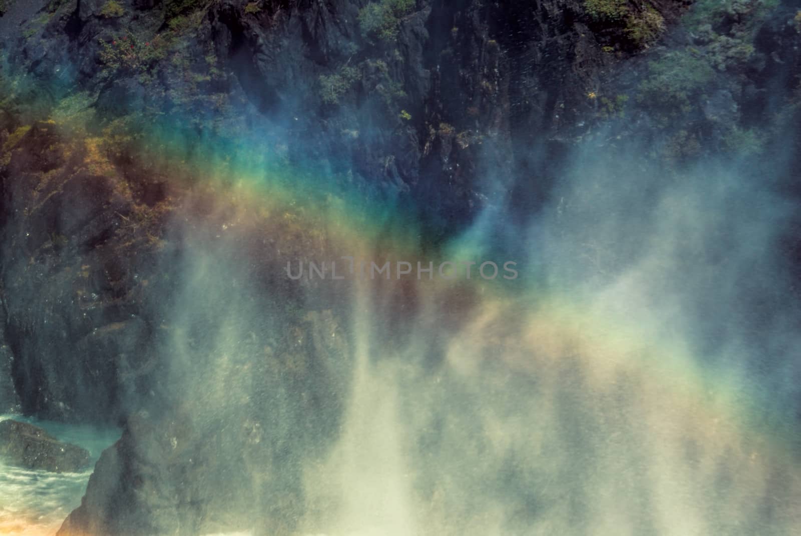 Rainbow in the mist over waterfall                