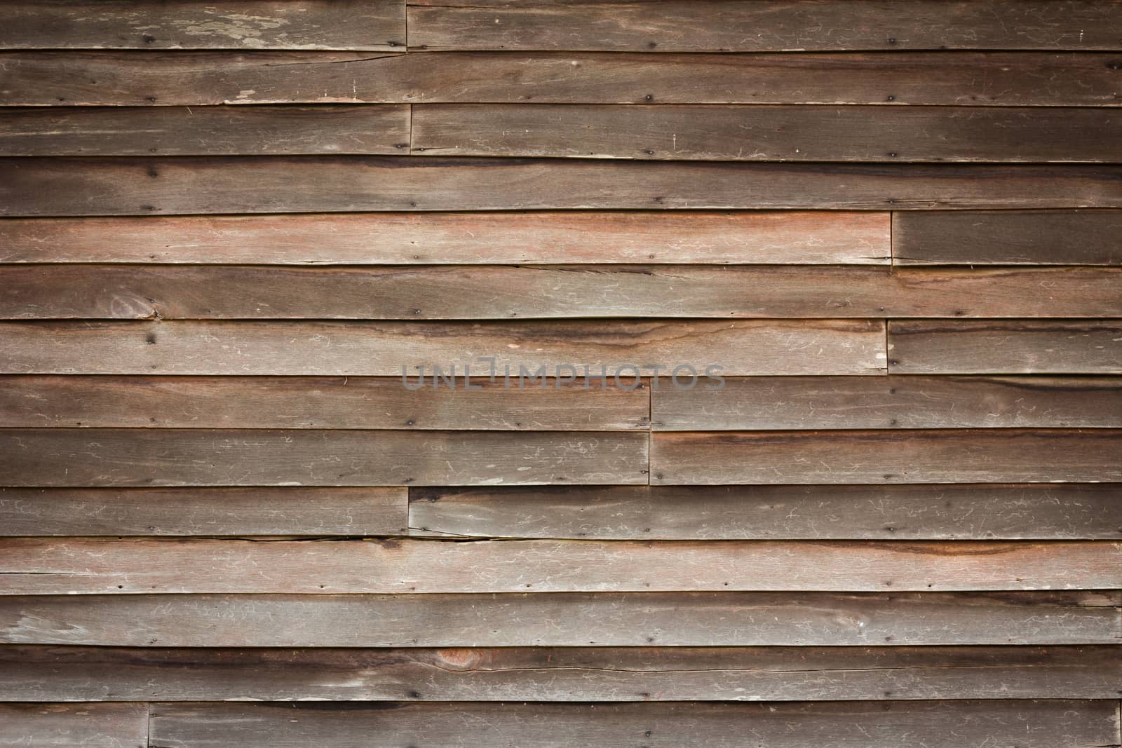 Perfectly lit wooden background with weathered wood and rusty nails