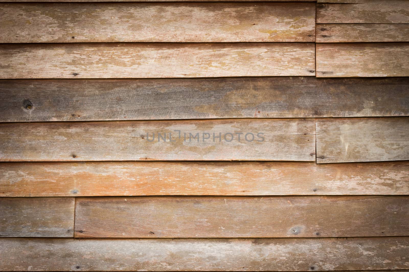 Perfectly lit wooden background with weathered wood and rusty nails