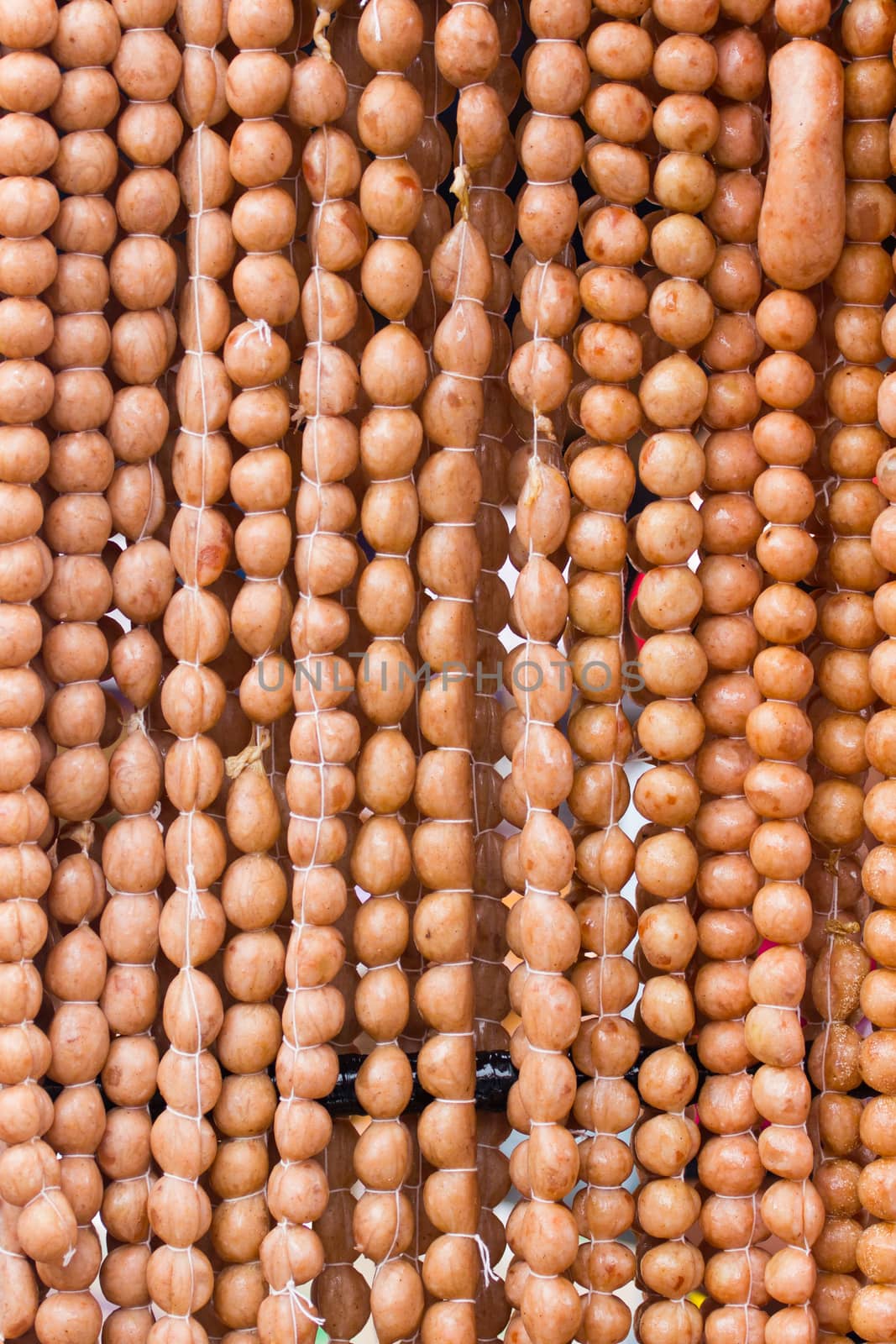 Traditional Thai food, pork sausage at street market, Thailand, background