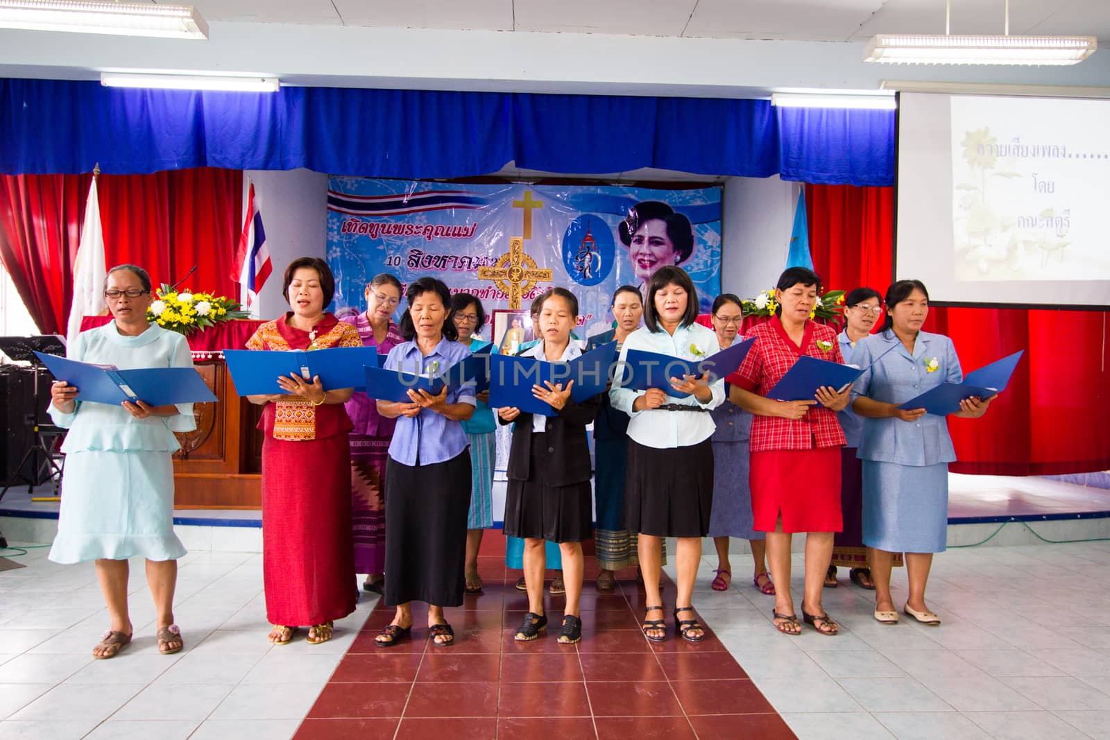 CHIANGRAI, THAILAND - AUG 10: unidentified women singing for Her Majesty Queen Sirikit in church on August 10, 2014 in Chiangrai, Thailand. Thai people in every religions always pray for the Queen in the occation of Her Mejesty Queen's Birthday (on August, 12)