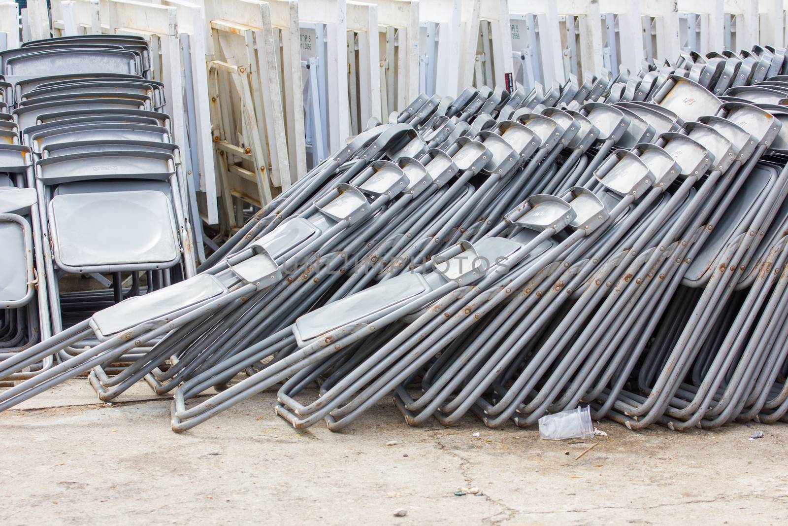 Rows of empty folding chairs outdoors