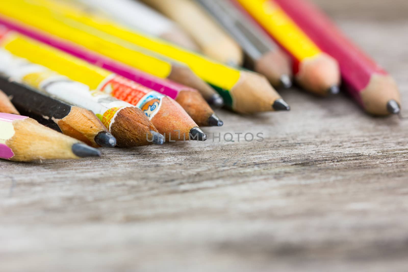 carbon crayon pencils on wooden floor, shallow depth of field.