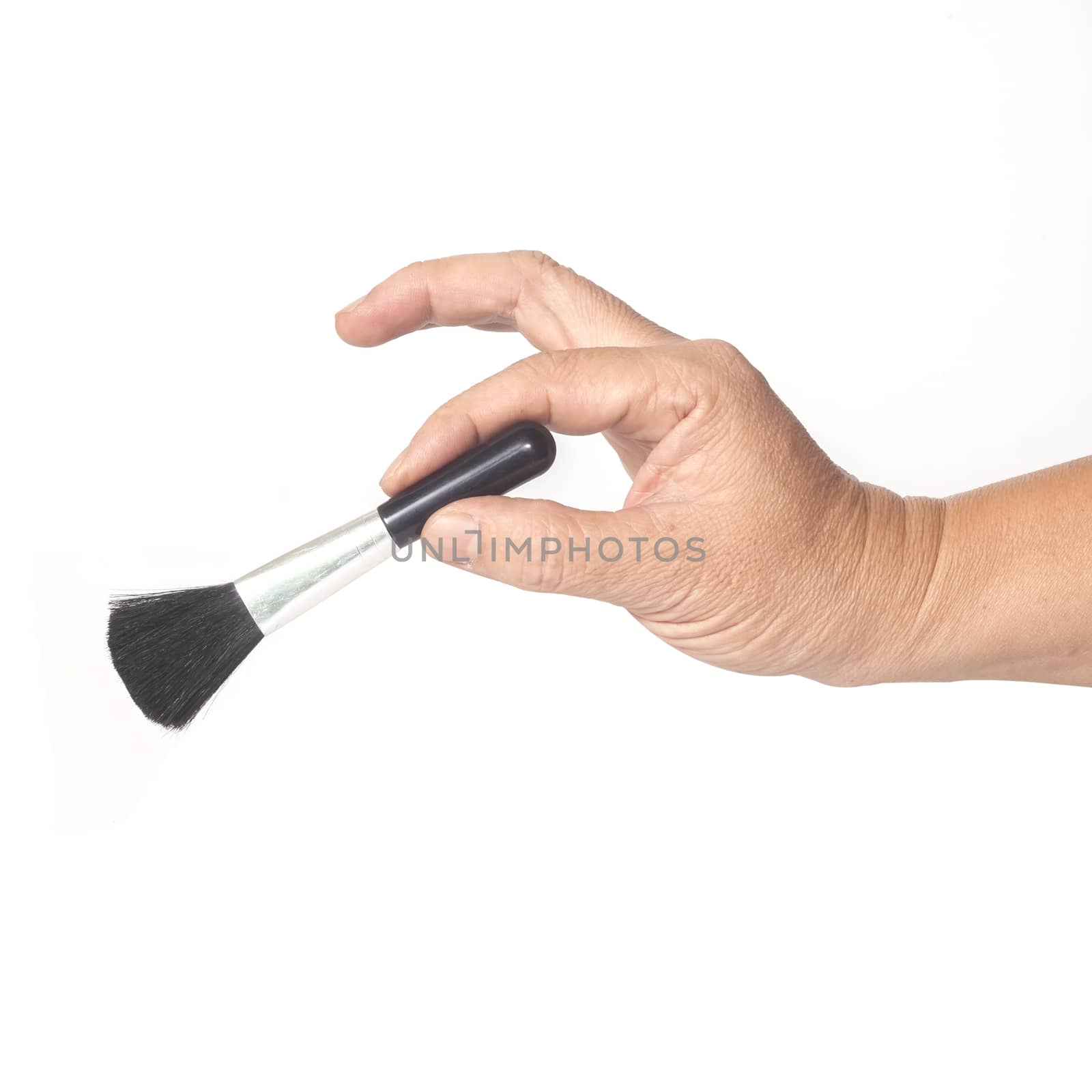 Brush in hand isolated on white background.
